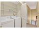 This laundry room includes a washer, dryer, and shelving at 2197 Spring Walk Ct, Atlanta, GA 30341
