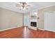 Inviting living room with wood floors, ceiling fan, and a charming fireplace with a decorative mantel at 2197 Spring Walk Ct, Atlanta, GA 30341