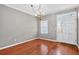 Sunlit dining area featuring hardwood floors, classic chandelier, and entry with large picture window at 2197 Spring Walk Ct, Atlanta, GA 30341