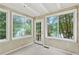 Bright sunroom surrounded by windows offering natural light and views of the greenery at 2197 Spring Walk Ct, Atlanta, GA 30341