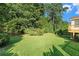 A lush backyard with a well-manicured lawn and mature trees bordering the property at 1290 Mount Mckinley Dr, Grayson, GA 30017