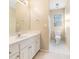 Bright bathroom featuring a white vanity, toilet, neutral walls and floors, and a window for natural light at 1290 Mount Mckinley Dr, Grayson, GA 30017