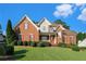 Charming two-story brick home featuring well-maintained landscaping and a welcoming front porch at 1290 Mount Mckinley Dr, Grayson, GA 30017