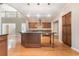 Open kitchen featuring a center island, modern lighting, and views of the living area at 1290 Mount Mckinley Dr, Grayson, GA 30017