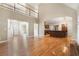 Expansive living area with hardwood floors, fireplace, and a view of the open kitchen and upper level at 1290 Mount Mckinley Dr, Grayson, GA 30017