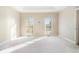 Spacious main bedroom with tray ceilings, carpeted floors and natural light at 1290 Mount Mckinley Dr, Grayson, GA 30017