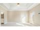 Bright main bedroom featuring tray ceilings, neutral walls, and a ceiling fan at 1290 Mount Mckinley Dr, Grayson, GA 30017