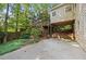 A wooden deck with stairs descends into a grassy backyard surrounded by lush trees and a wooden fence at 1902 Connemara Dr, Atlanta, GA 30341