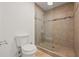 Modern bathroom featuring tiled walk-in shower and a contemporary toilet for comfort and style at 1902 Connemara Dr, Atlanta, GA 30341