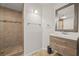 Stylish bathroom featuring tiled walk-in shower and a floating vanity, combining functionality and aesthetics at 1902 Connemara Dr, Atlanta, GA 30341