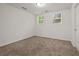 Cozy bedroom with neutral carpet, two windows allowing natural light, and a closet for storage at 1902 Connemara Dr, Atlanta, GA 30341