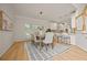 Contemporary dining room with hardwood floors, pendant lighting and an open view to the kitchen at 1902 Connemara Dr, Atlanta, GA 30341