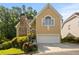 Charming home with a stone chimney, manicured landscaping and an attached two-car garage at 1902 Connemara Dr, Atlanta, GA 30341