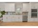 Modern kitchen with white cabinets, subway tile backsplash, stainless steel appliances and hardwood floors at 1902 Connemara Dr, Atlanta, GA 30341