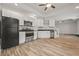 Spacious kitchen includes stainless steel appliances, white cabinetry, and breakfast bar with hardwood floors at 1902 Connemara Dr, Atlanta, GA 30341
