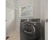 Laundry room boasts modern front load washer and dryer beneath a bright window at 1902 Connemara Dr, Atlanta, GA 30341