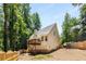 Backyard of home features deck, fence, and mature trees at 7167 Stonebrook Ln, Lithonia, GA 30058