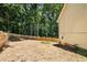 View of backyard and a portion of the side of the house with tan siding and fencing at 7167 Stonebrook Ln, Lithonia, GA 30058