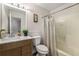 Well-lit bathroom with wood vanity, white countertops, and shower-tub combination at 7167 Stonebrook Ln, Lithonia, GA 30058