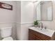 Updated bathroom with decorative mirror, stylish vanity, and modern fixtures at 7167 Stonebrook Ln, Lithonia, GA 30058