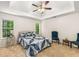 Calm bedroom with a tray ceiling, cozy carpet, and a decorative quilt at 7167 Stonebrook Ln, Lithonia, GA 30058