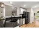 Modern kitchen with granite countertops, stainless steel appliances and breakfast bar at 7167 Stonebrook Ln, Lithonia, GA 30058