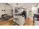 Open kitchen and living room floor plan with stainless steel appliances and breakfast bar at 7167 Stonebrook Ln, Lithonia, GA 30058