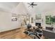 Comfortable living room with a fireplace, natural light, and hardwood floors at 7167 Stonebrook Ln, Lithonia, GA 30058