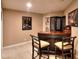 Basement bar area with stools, decorative screen, and carpeted flooring at 1850 Noblin Ridge Way, Duluth, GA 30097