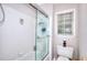 Bathroom featuring a glass-enclosed shower, white tile, and window at 1850 Noblin Ridge Way, Duluth, GA 30097