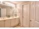 Bright bathroom with double vanity and large mirror, offering ample space and natural light at 1850 Noblin Ridge Way, Duluth, GA 30097