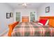 Bedroom featuring a wooden bed frame, a plaid comforter, and a three-drawer chest at 1850 Noblin Ridge Way, Duluth, GA 30097