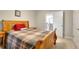 Bedroom with a wooden bed frame, a plaid comforter, and a view of the upstairs hallway at 1850 Noblin Ridge Way, Duluth, GA 30097