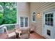 Outdoor deck with a seating area for entertaining, featuring a door to enter into the home at 1850 Noblin Ridge Way, Duluth, GA 30097