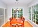 Bright dining room with large windows, wood floors, and stylish chandelier at 1850 Noblin Ridge Way, Duluth, GA 30097