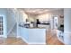 Bright kitchen with white cabinets, stainless steel appliances, granite countertops and hardwood floors at 1850 Noblin Ridge Way, Duluth, GA 30097