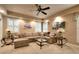 Well-lit living room with comfortable sectional sofa, decorative tables, and neutral carpeting at 1850 Noblin Ridge Way, Duluth, GA 30097