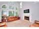 Bright living room with large windows, fireplace, and comfortable seating at 1850 Noblin Ridge Way, Duluth, GA 30097