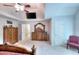 Bedroom with decorative dressers and a large mirror. Carpeted floors with a ceiling fan at 1850 Noblin Ridge Way, Duluth, GA 30097