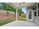 Covered back porch with concrete patio, views of a grassy, fenced backyard at 614 Denali Dr, Mableton, GA 30126