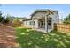 Expansive backyard with green lawn, privacy fence, and a covered patio at 614 Denali Dr, Mableton, GA 30126