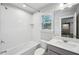 Bright bathroom featuring a white subway tiled shower-tub and a single sink vanity at 614 Denali Dr, Mableton, GA 30126