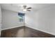 Cozy bedroom with hardwood floors, ceiling fan, and a bright window at 614 Denali Dr, Mableton, GA 30126