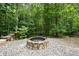 Outdoor fire pit with a wooded backdrop, ideal for relaxation and entertainment at 614 Denali Dr, Mableton, GA 30126