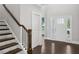 Bright foyer with hardwood floors, staircase, and natural light streaming through the window at 614 Denali Dr, Mableton, GA 30126