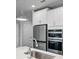 Bright kitchen features stainless steel appliances, white cabinetry, and modern faucet at 614 Denali Dr, Mableton, GA 30126