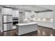 Bright kitchen with island, stainless appliances, tile backsplash, and dark hardwood flooring at 614 Denali Dr, Mableton, GA 30126