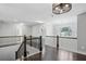 Upper landing with wood floors, iron railing, and decorative lighting at 614 Denali Dr, Mableton, GA 30126