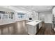 Living room with hardwood floors open to kitchen area with white cabinets and stainless steel appliances at 614 Denali Dr, Mableton, GA 30126