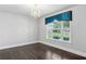 Stylish room featuring dark hardwood floors, neutral walls, a window and a modern chandelier at 614 Denali Dr, Mableton, GA 30126